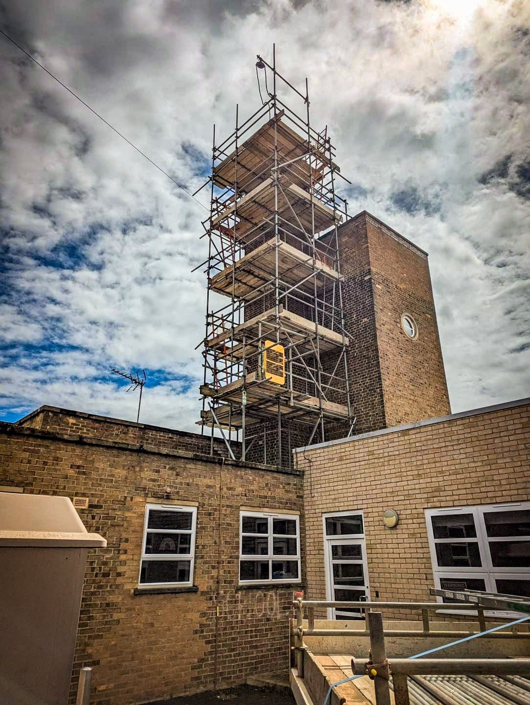 Scaffolding around a brick building
